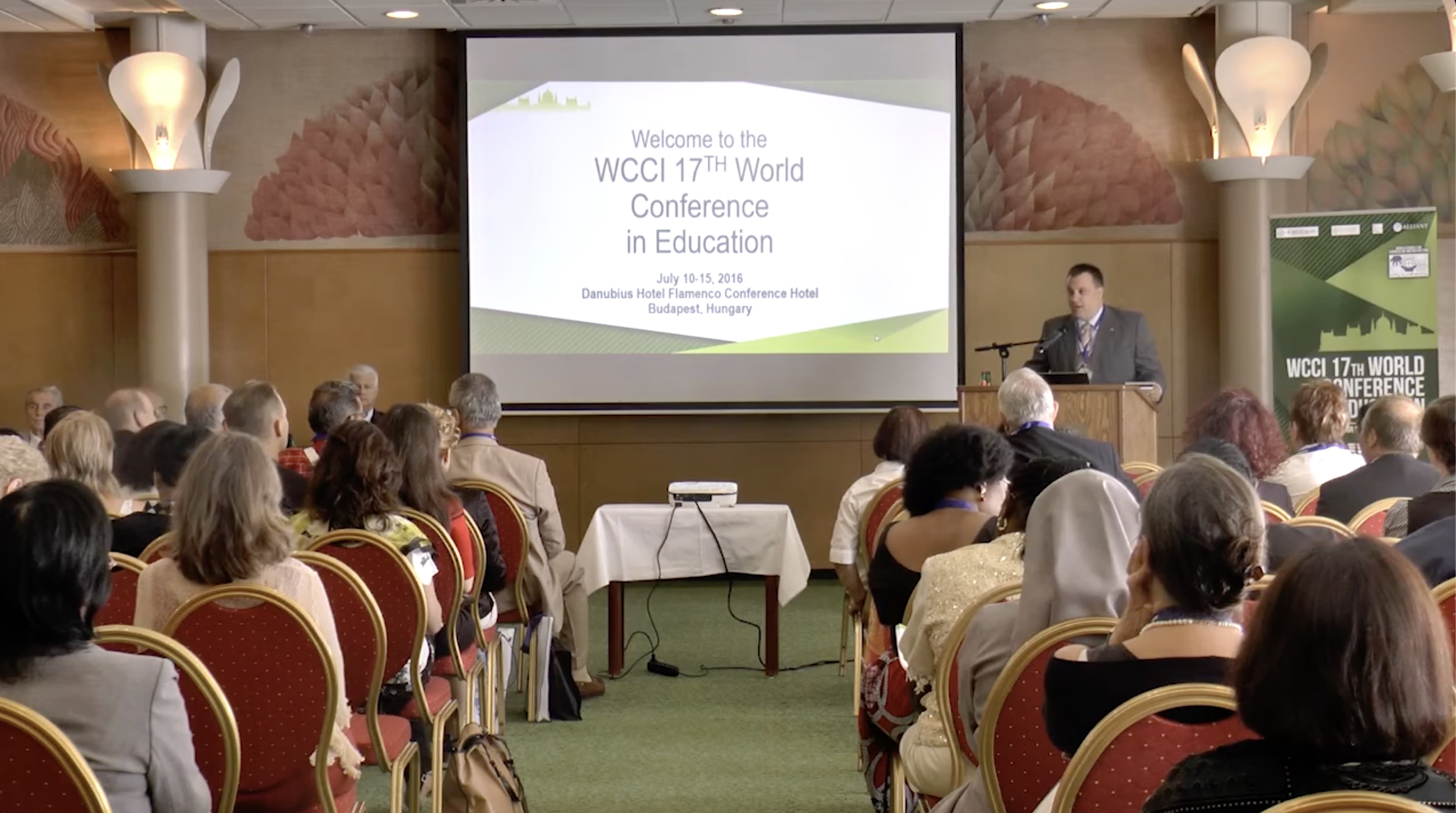 People at a concert facing the stage with various colours of paint powder in the air